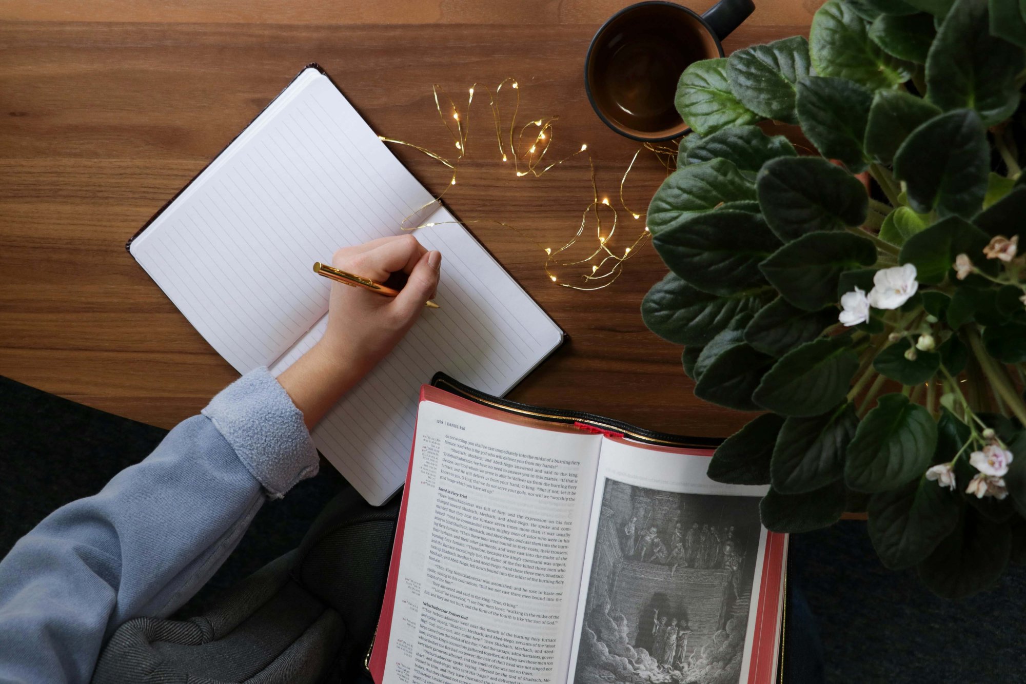 A person reading the bible and taking notes